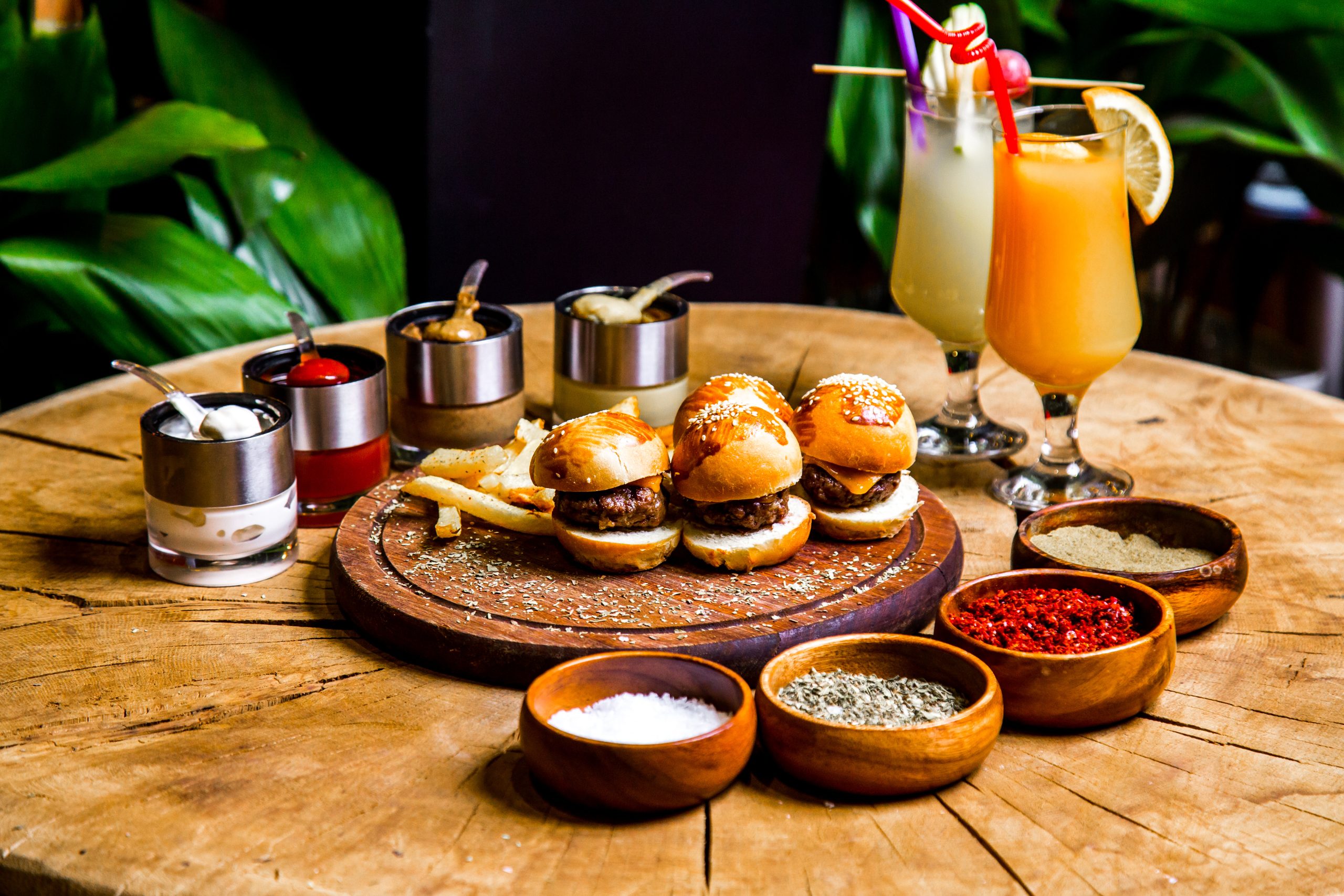 mini burgers french fries spices sauces cocktails side view scaled